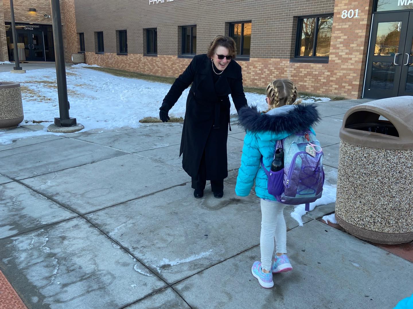 teacher greeting students