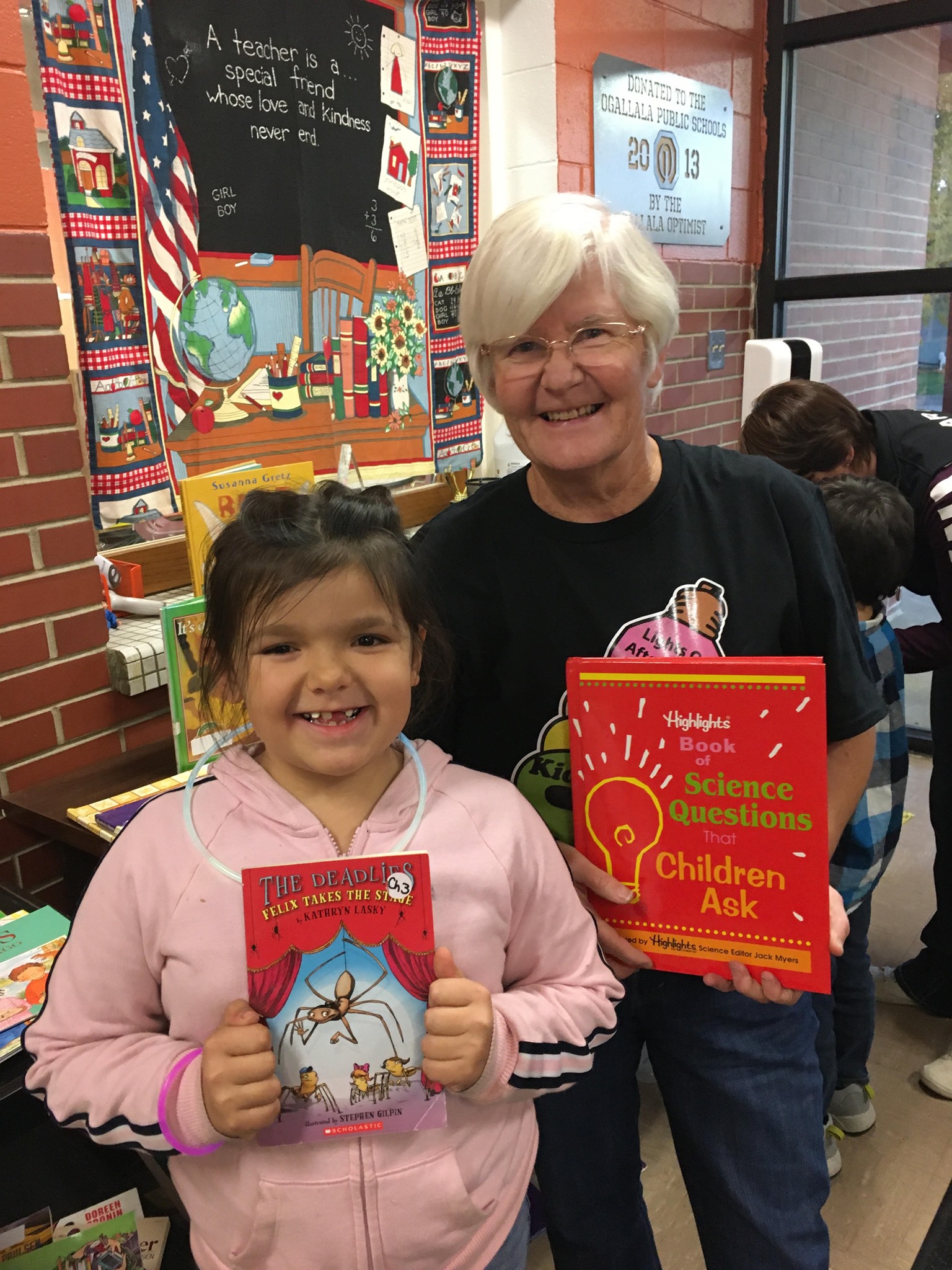 student and teacher with books