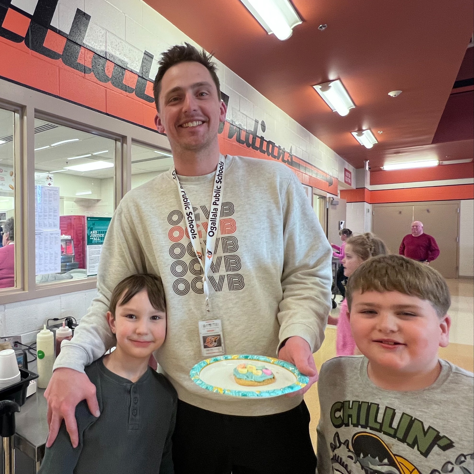 students with teacher and cookie