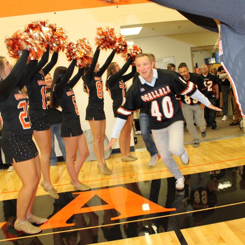 teacher running through tunnel of arms