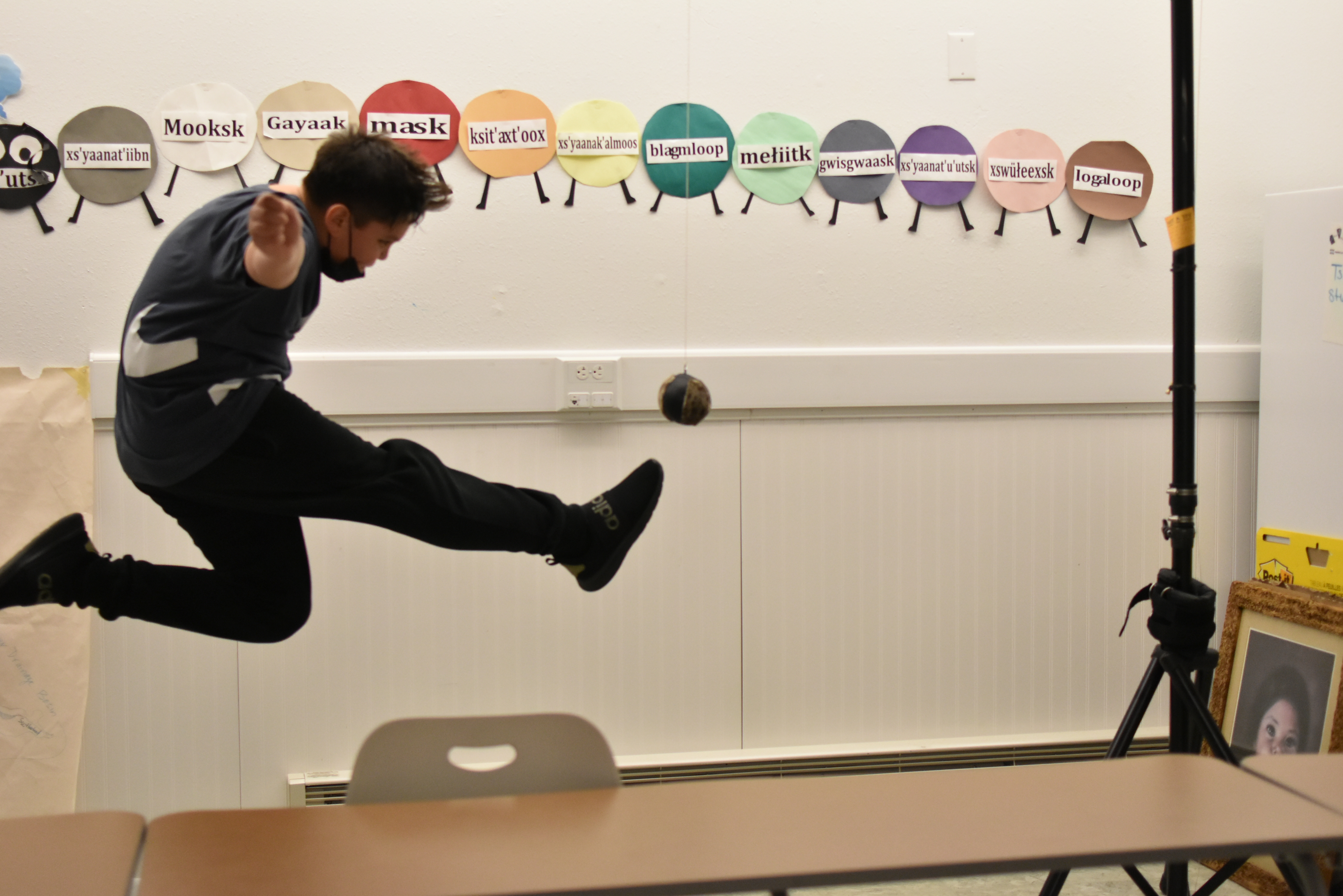 student jumping and kicking