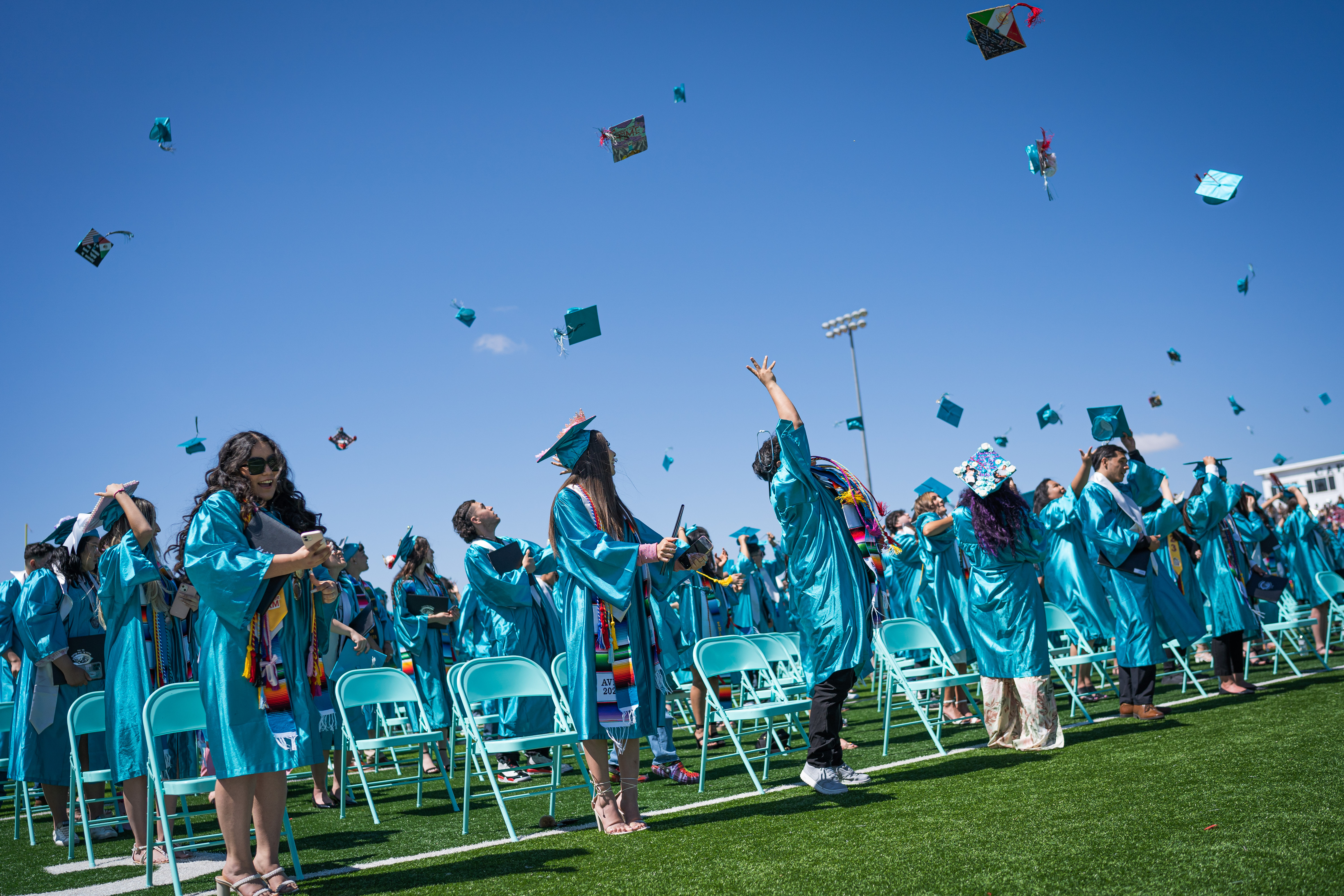 students throwing their graduation cap in the air