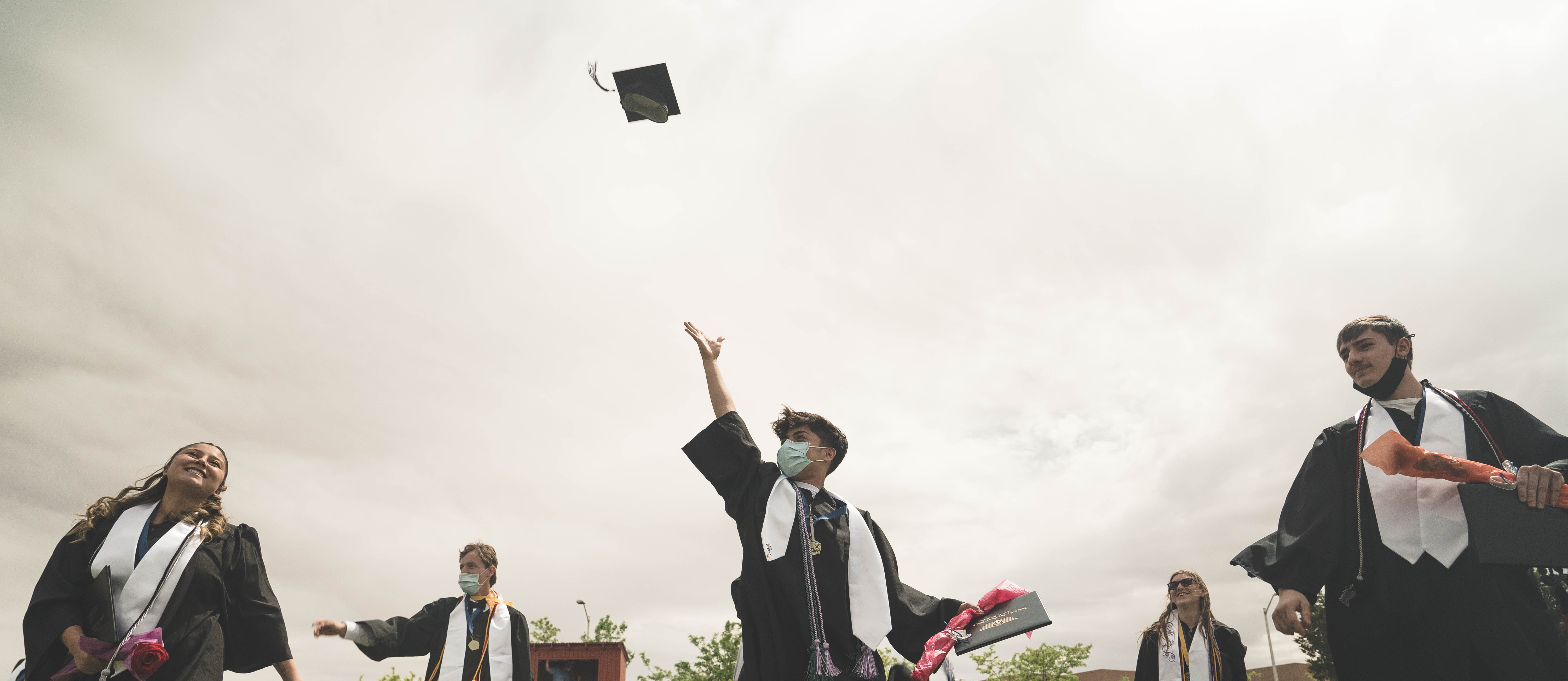 ECO Student throwing Graduation cap
