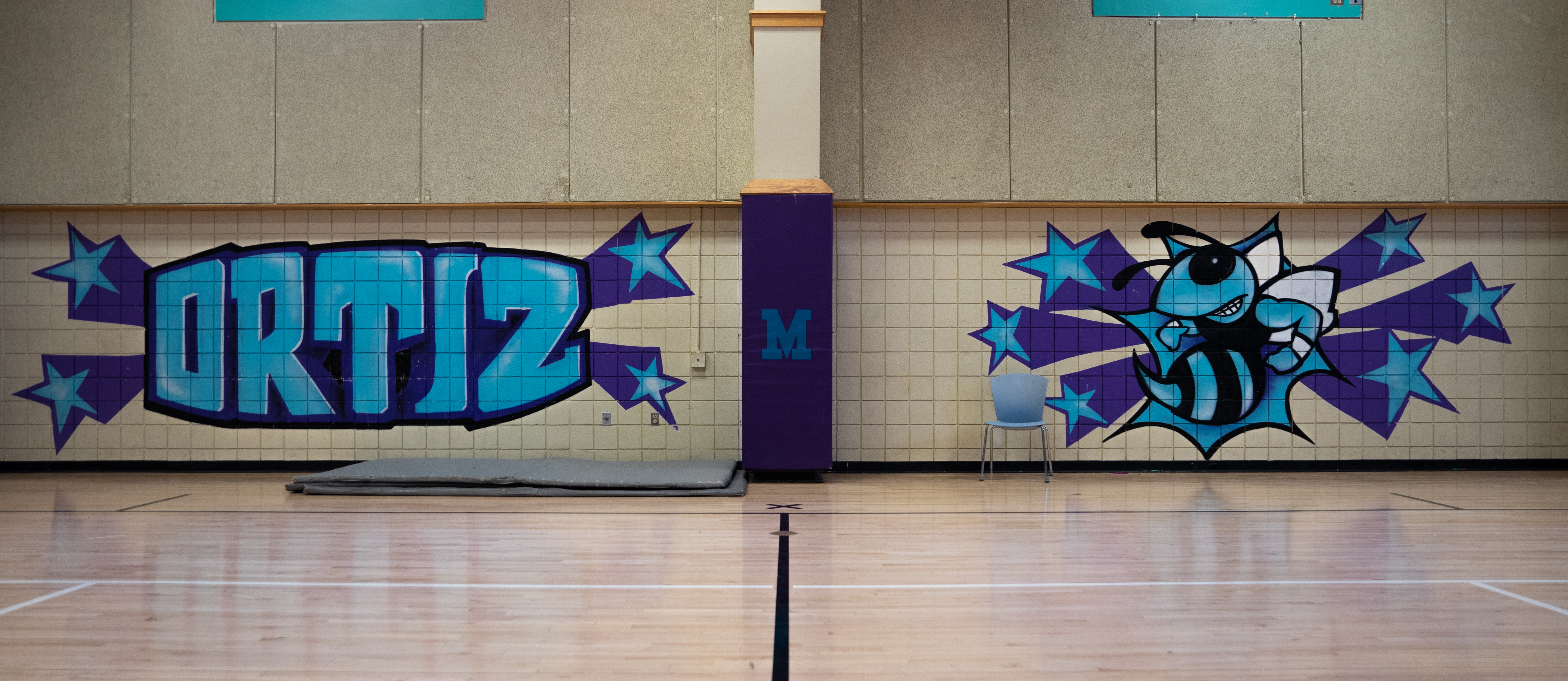 Gym Wall with blue and purple Ortiz and a Hornet