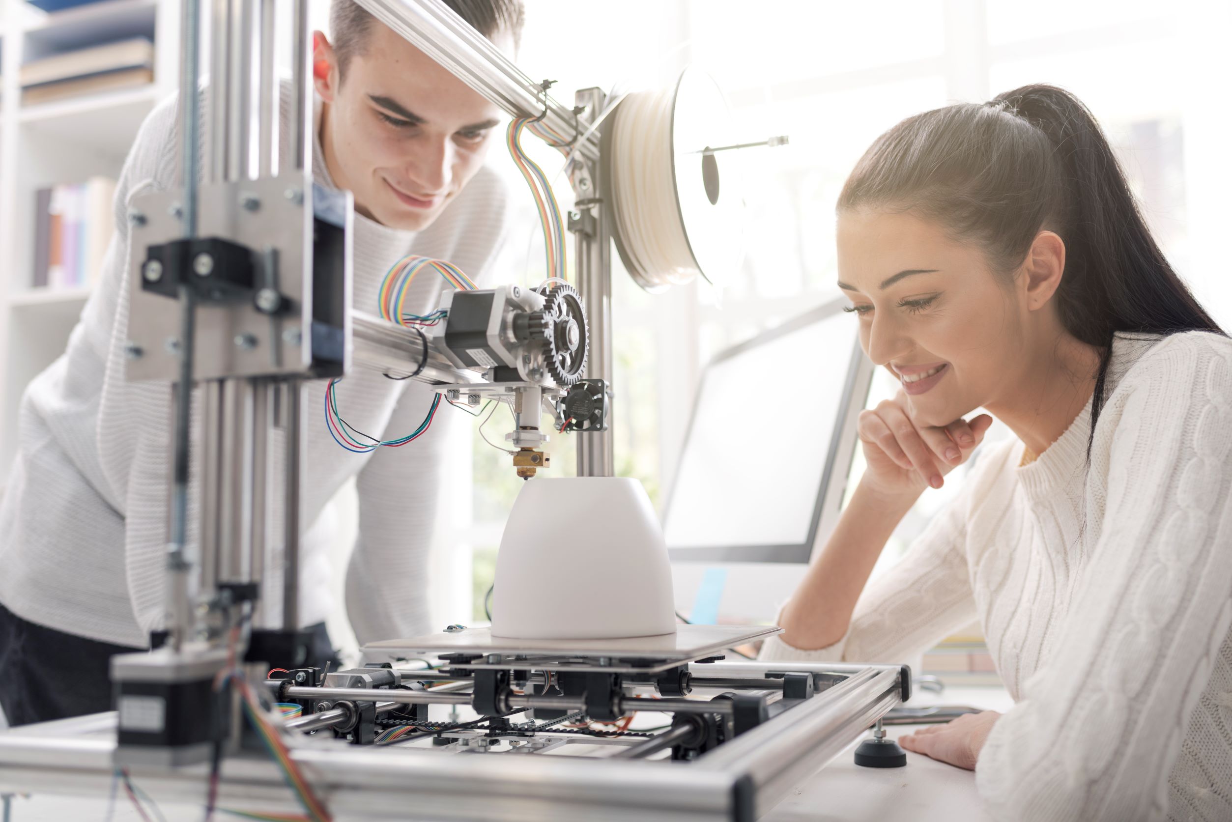 Students watching a 3D printer