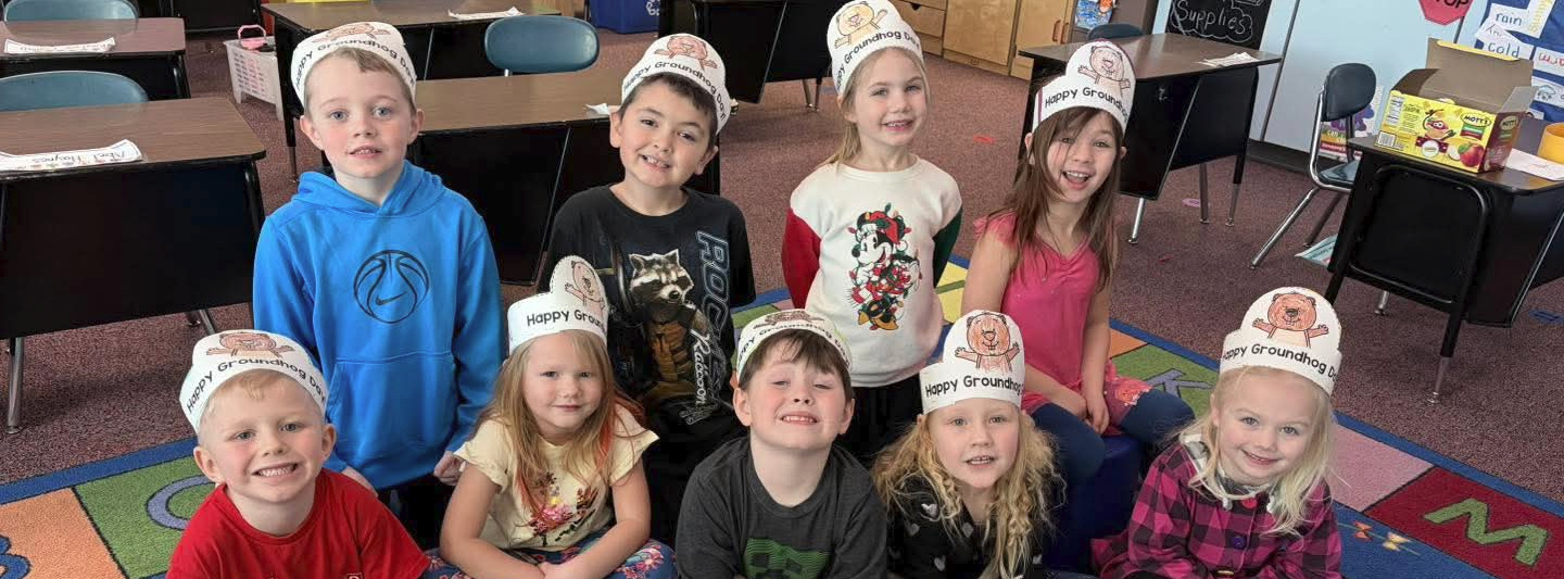 children, colorful rug, desks, book shelves