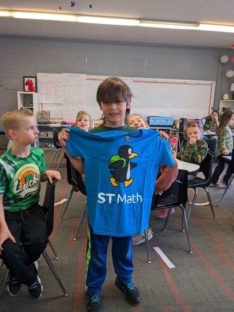 Student posing with shirt that reads ST math