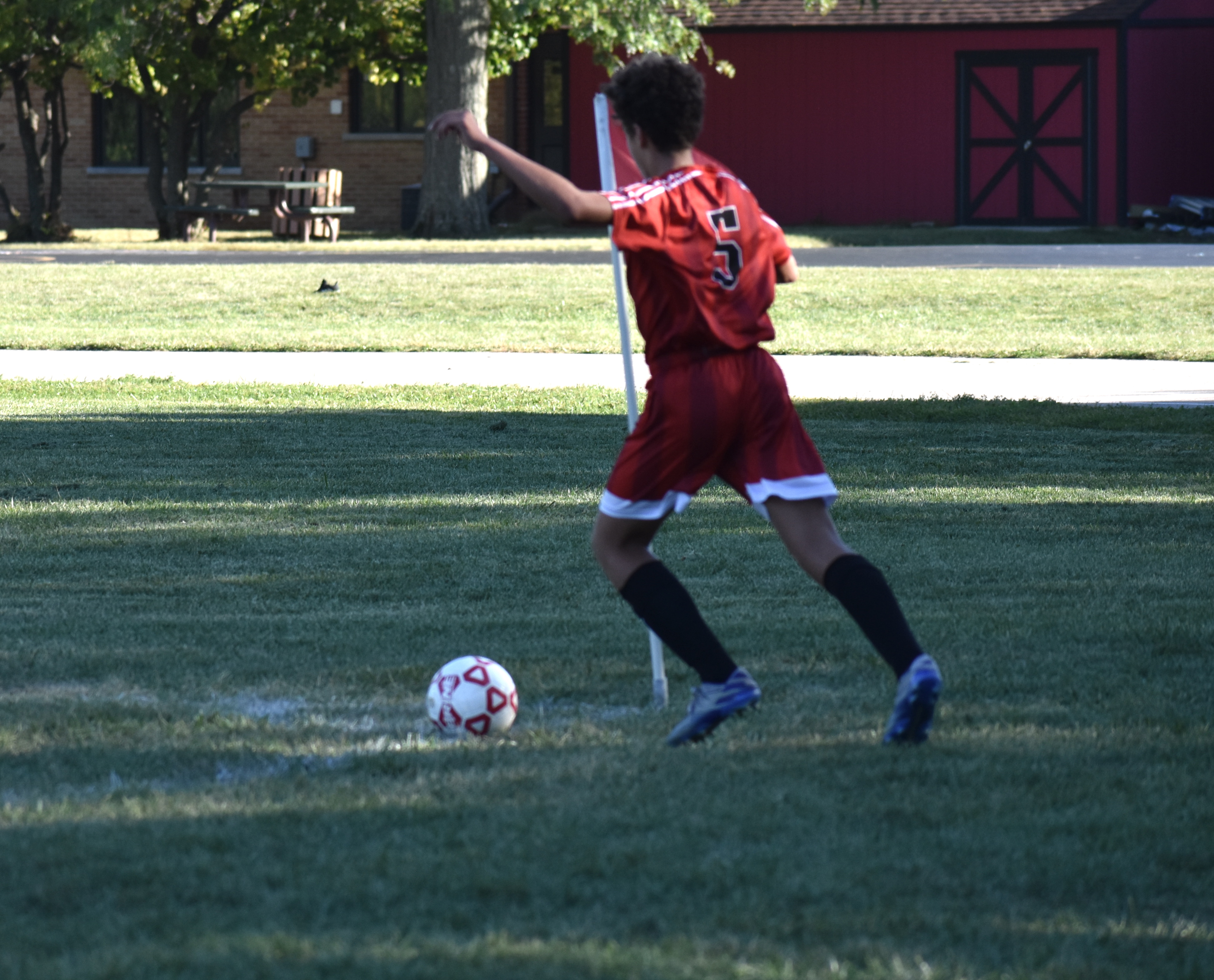 soccer player gets ready to kick the ball into play during a game
