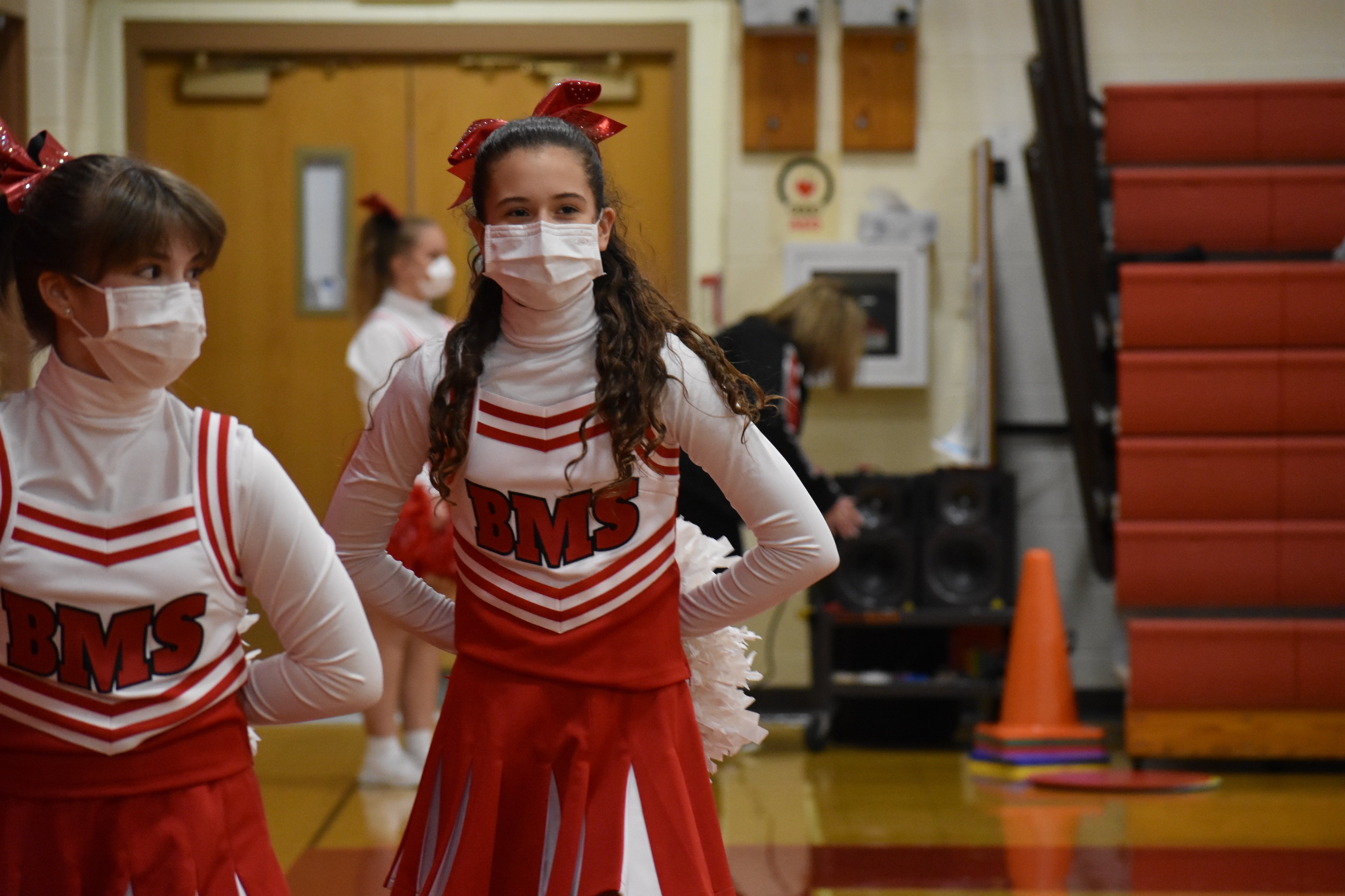 Dance and cheer member walks out onto the gym floor for a performance