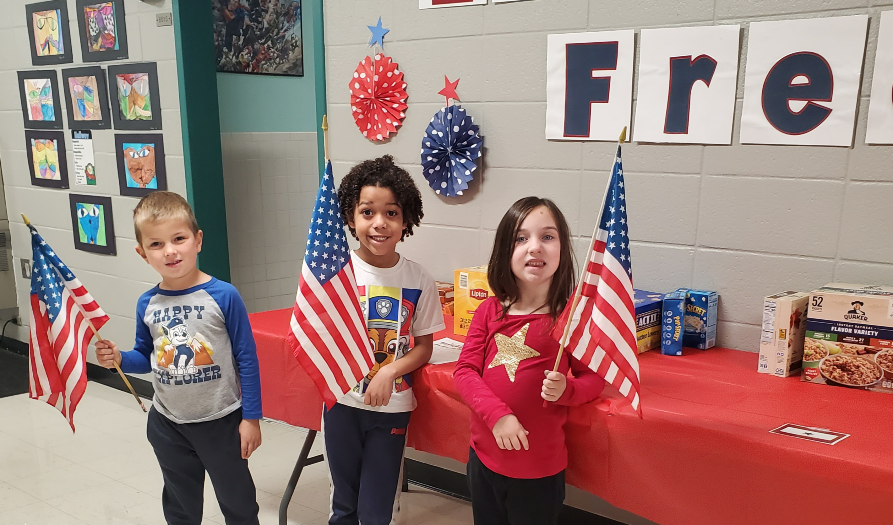 Kindergarten Students holding American flags showing support of our Veterans