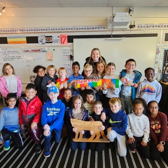 Westwood Elementary class posing for a group photo in their classroom with their teacher