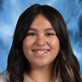 Headshot of student with a blue background