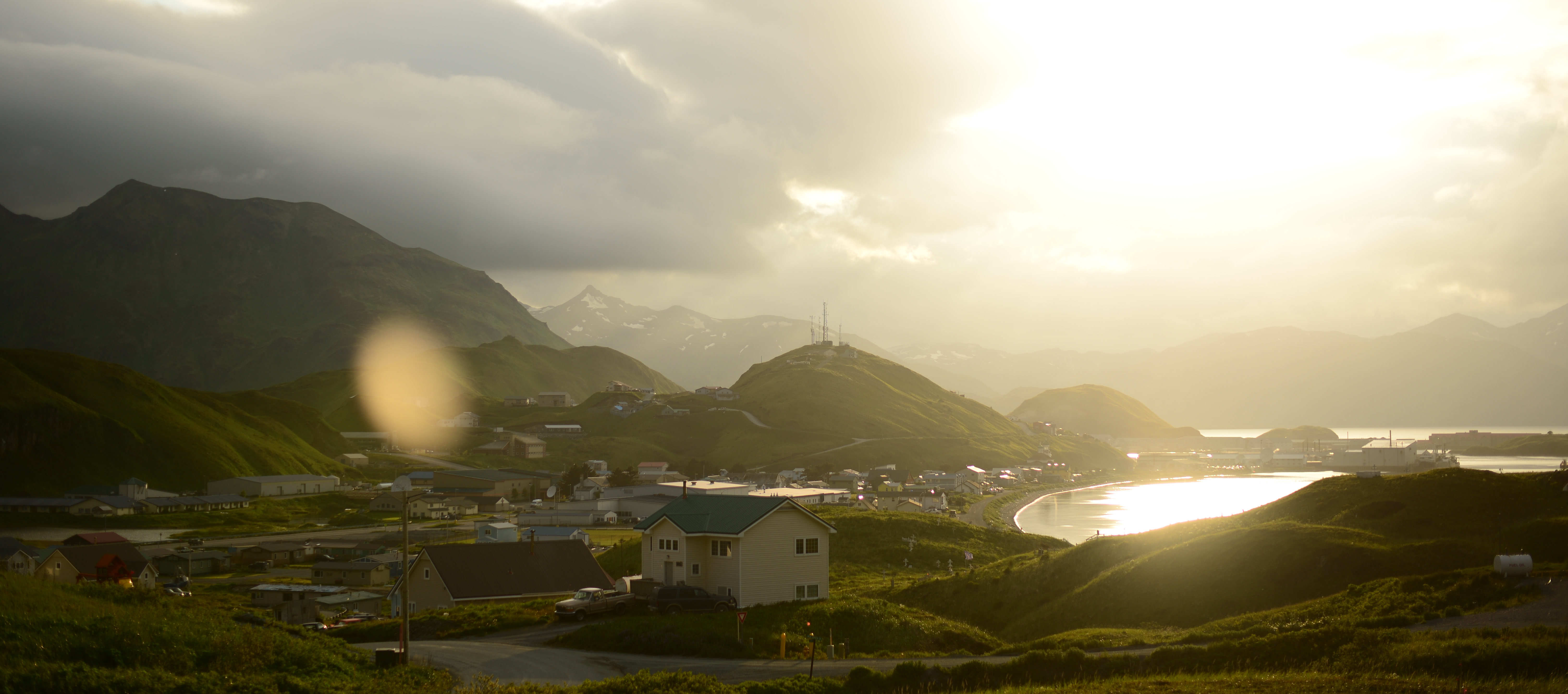 Home on a hill with mountains and clouds