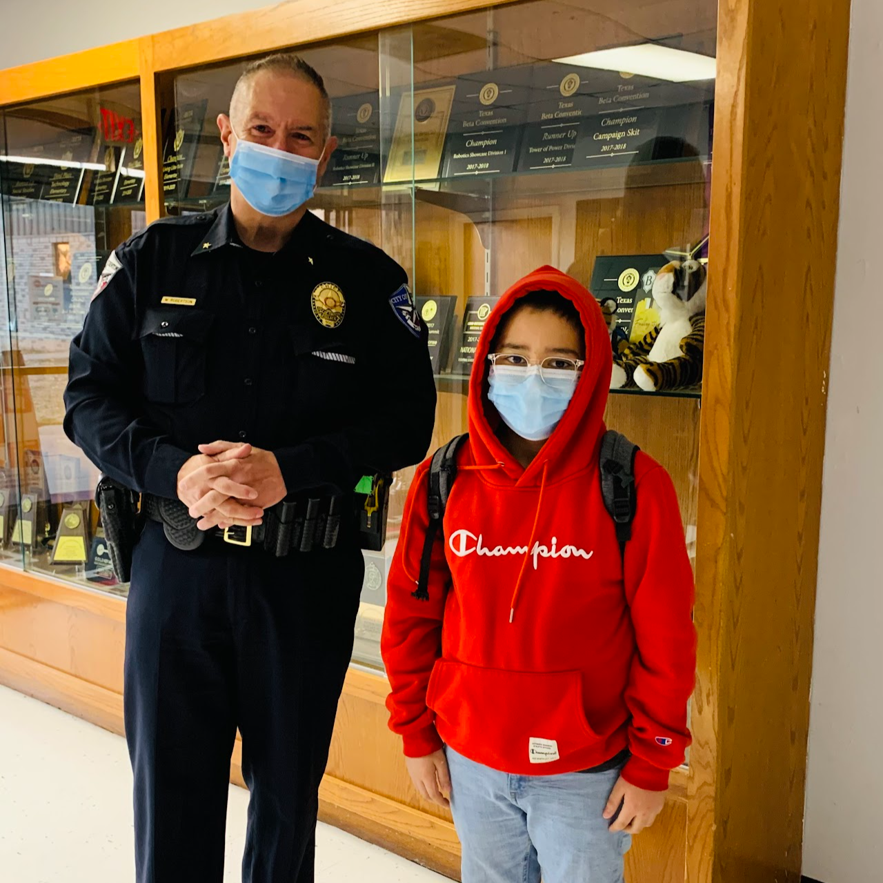 Photo of a campus police officer next to a student