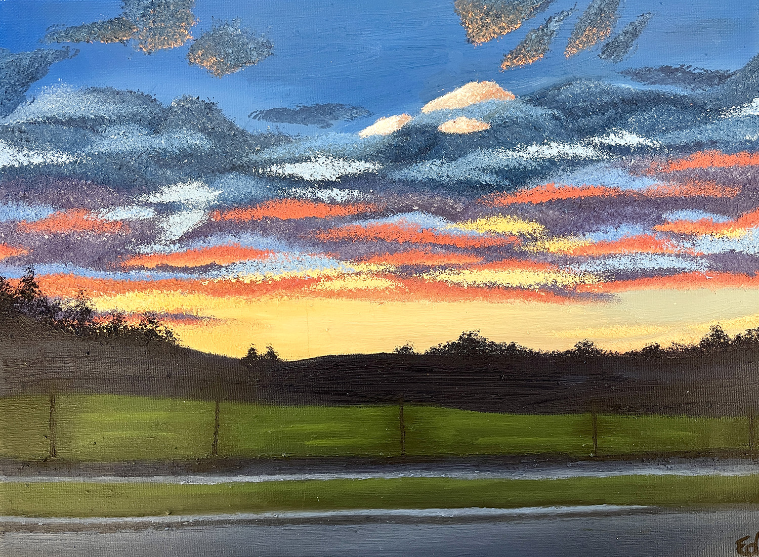 Student painting by Emma Davies called Apalachin Sunset. It shows green fields and a darker silhouette of hills beneath a vibrant blue, red and orange sky with clouds.