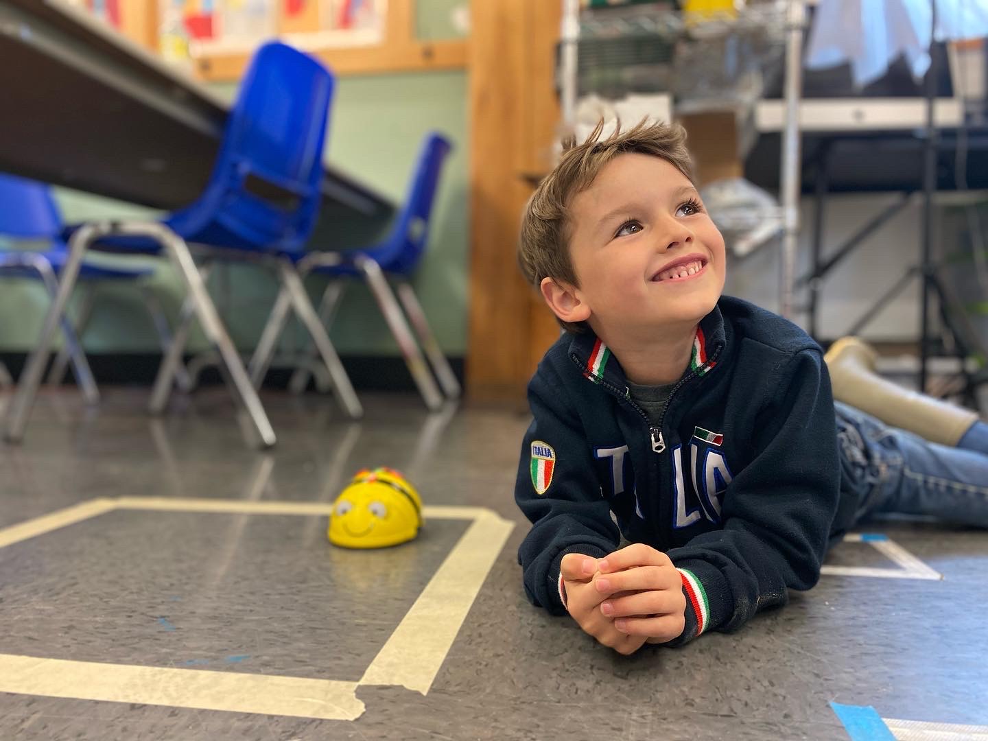 Student smiling with bee bot