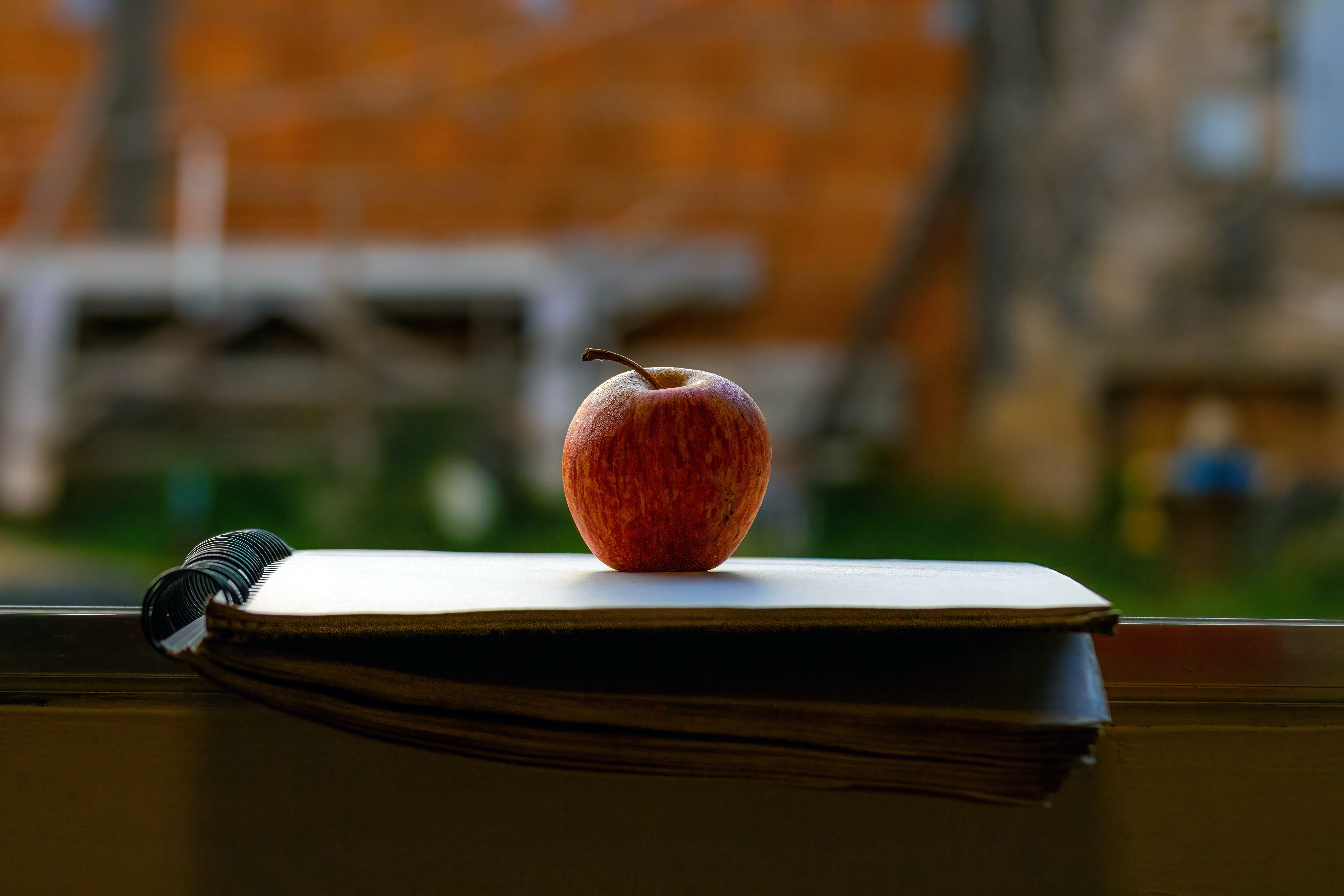 Apple on top of notebook