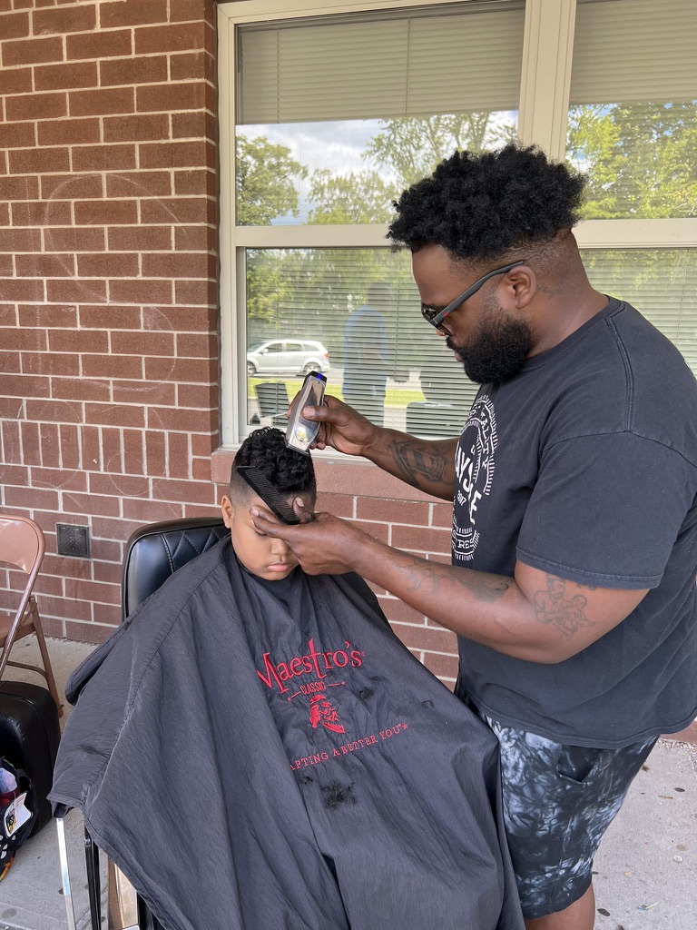 PHOTO HAIRCUTS AT SHS Principal Green had his own barber spend the afternoon at Schenectady High School on 9/27 for the Back to School Kick Off party. There was also hair braiding, prizes, food, snow cones, community organizations, and a DJ. Thanks to all who came out and shared in the excitement around returning to school.