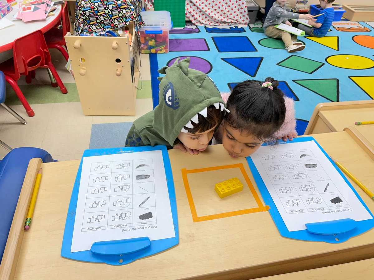 Photo of the week:  These two kindergarten students attempt to blow down a house made of Lego bricks after reading "The 3 Little Pigs"