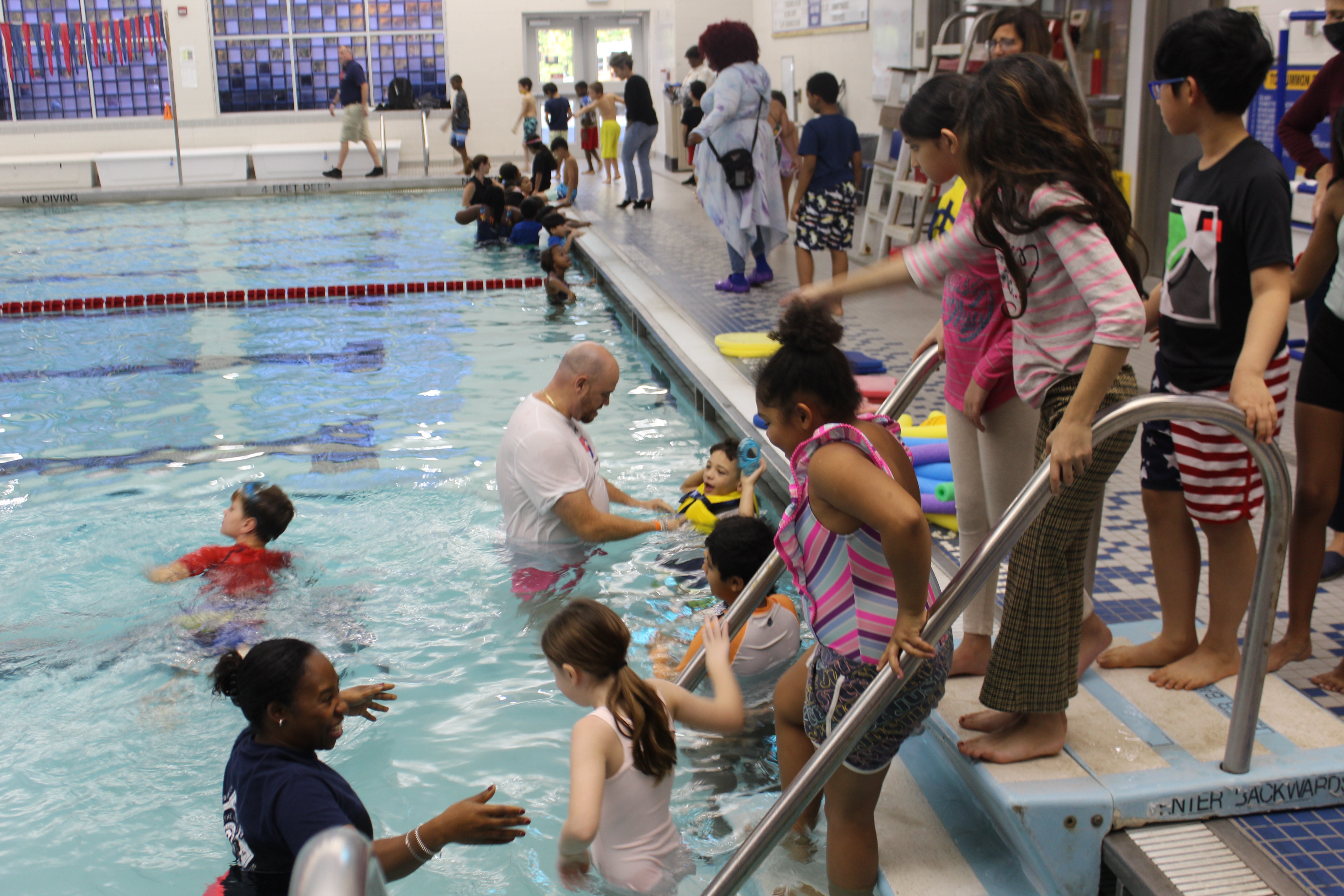 Photo:  Supt Soler swimming with third graders