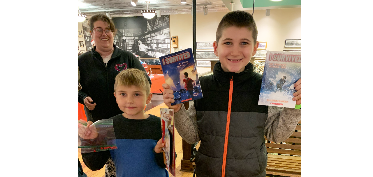 2 boys holding books