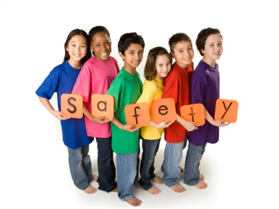 Kids holding a sign that says safety