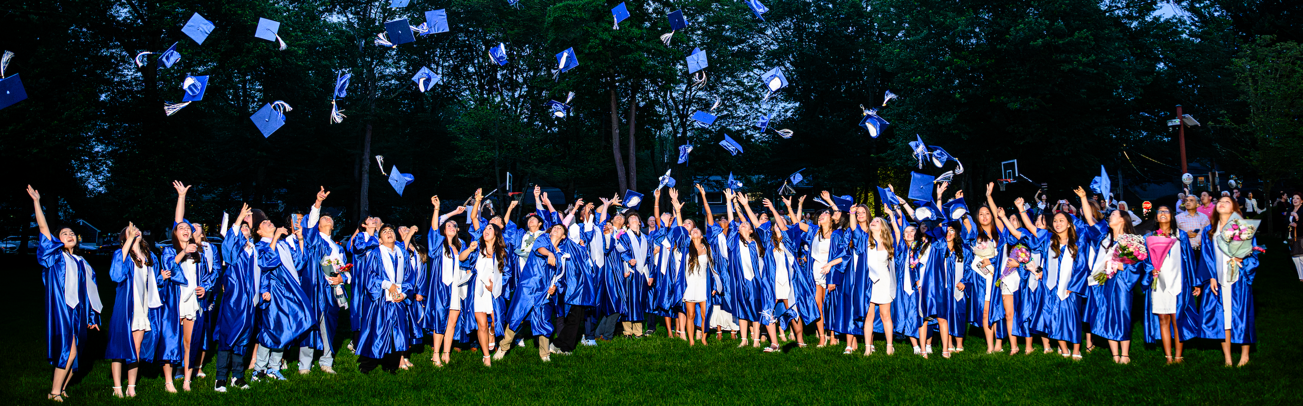 2025 Graduting Class in the Harrington Park School Back Field Throwing their caps in the air after graduating