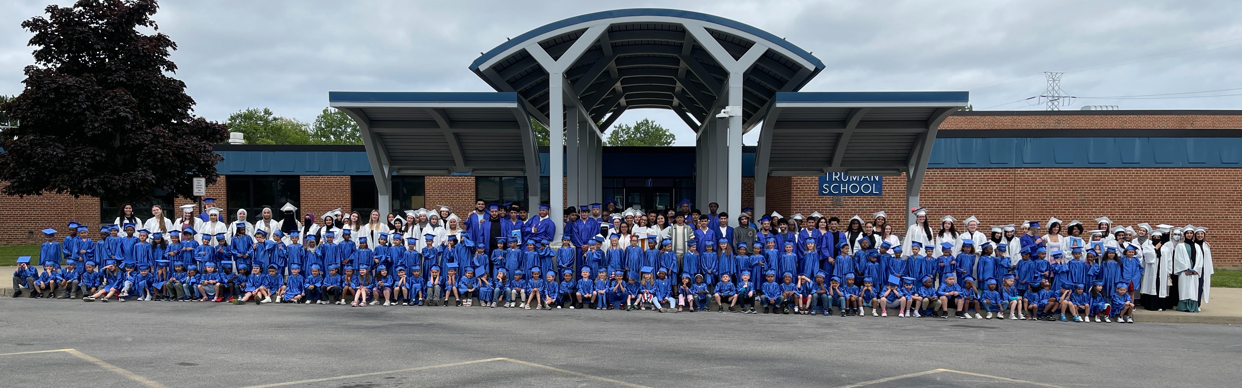 Truman students pose with graduates.