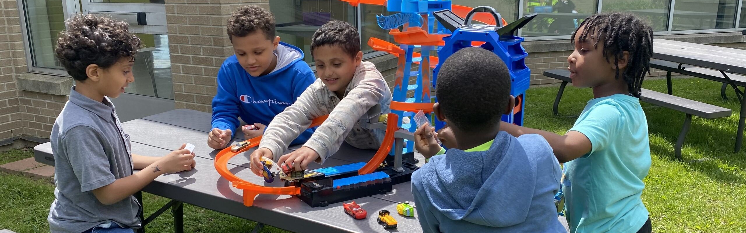 Students play with toy cars