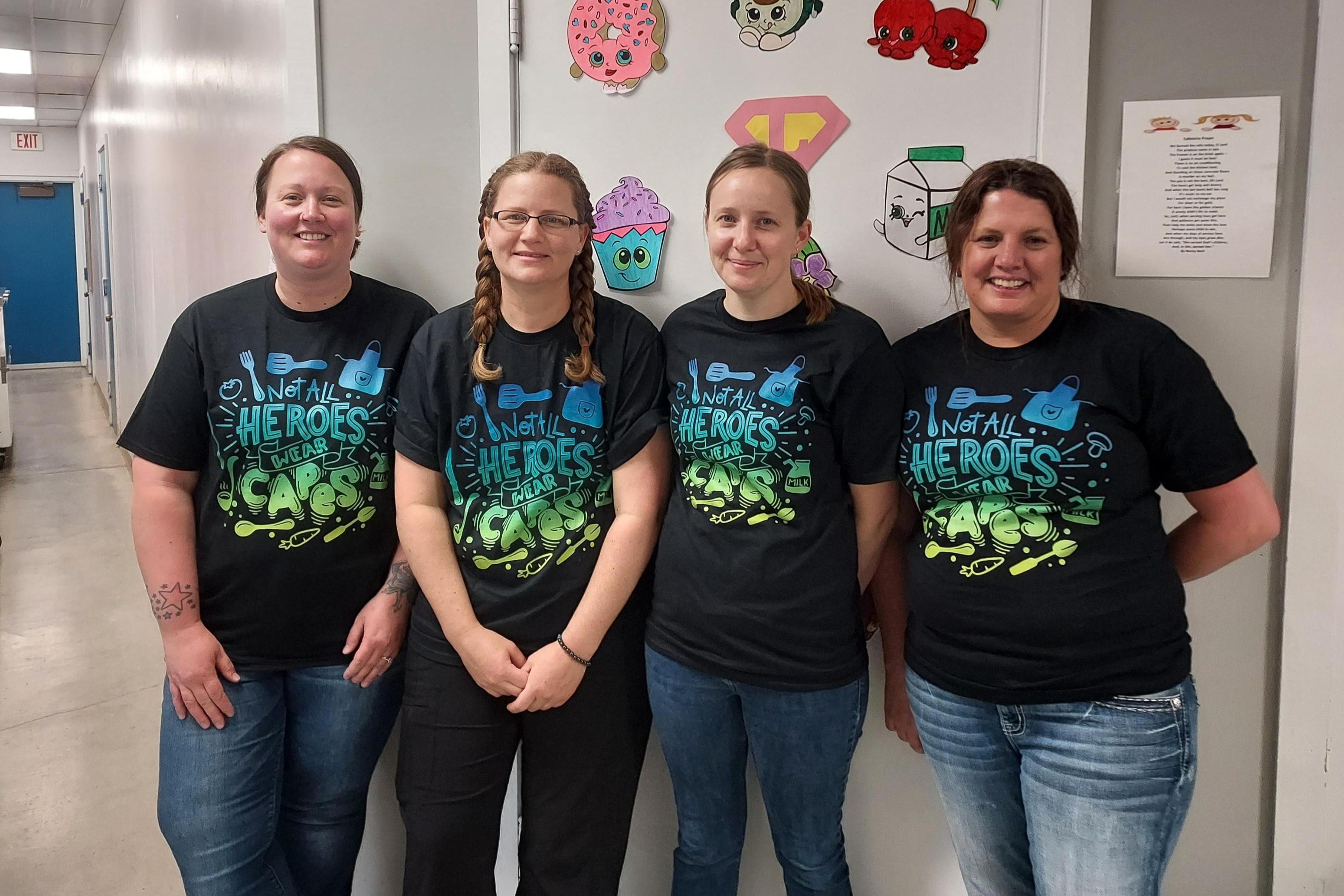 4 kitchen staff in matching shirts