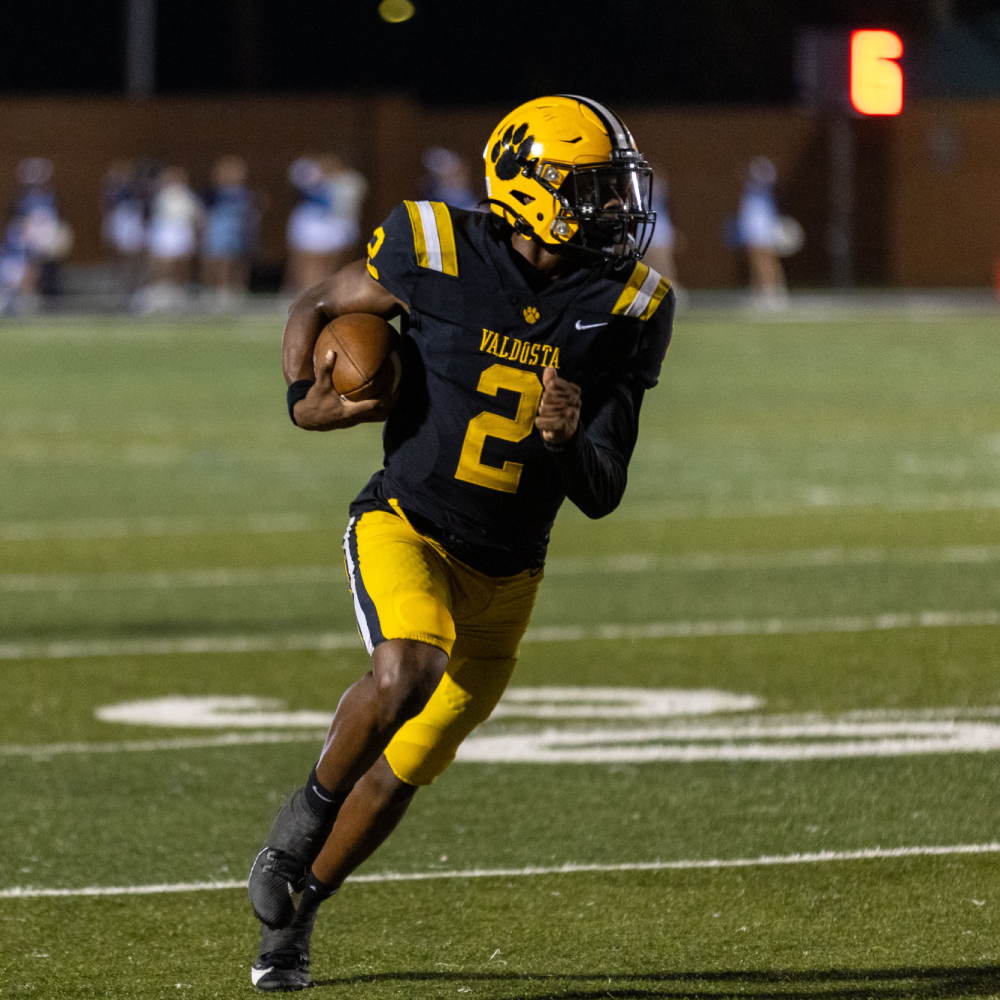 VHS Football player running with ball in hand