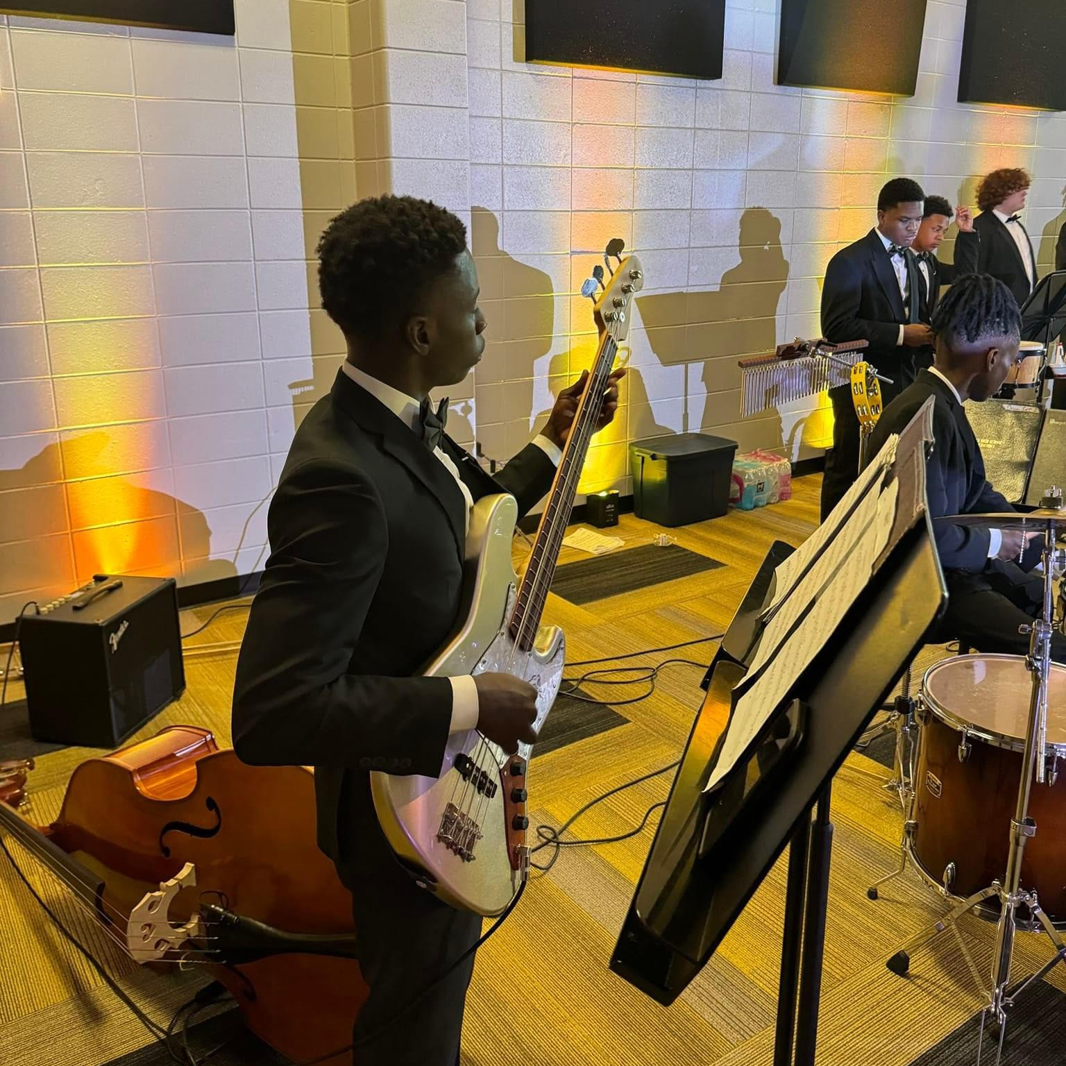 Student participating in VHS band, playing a bass guitar