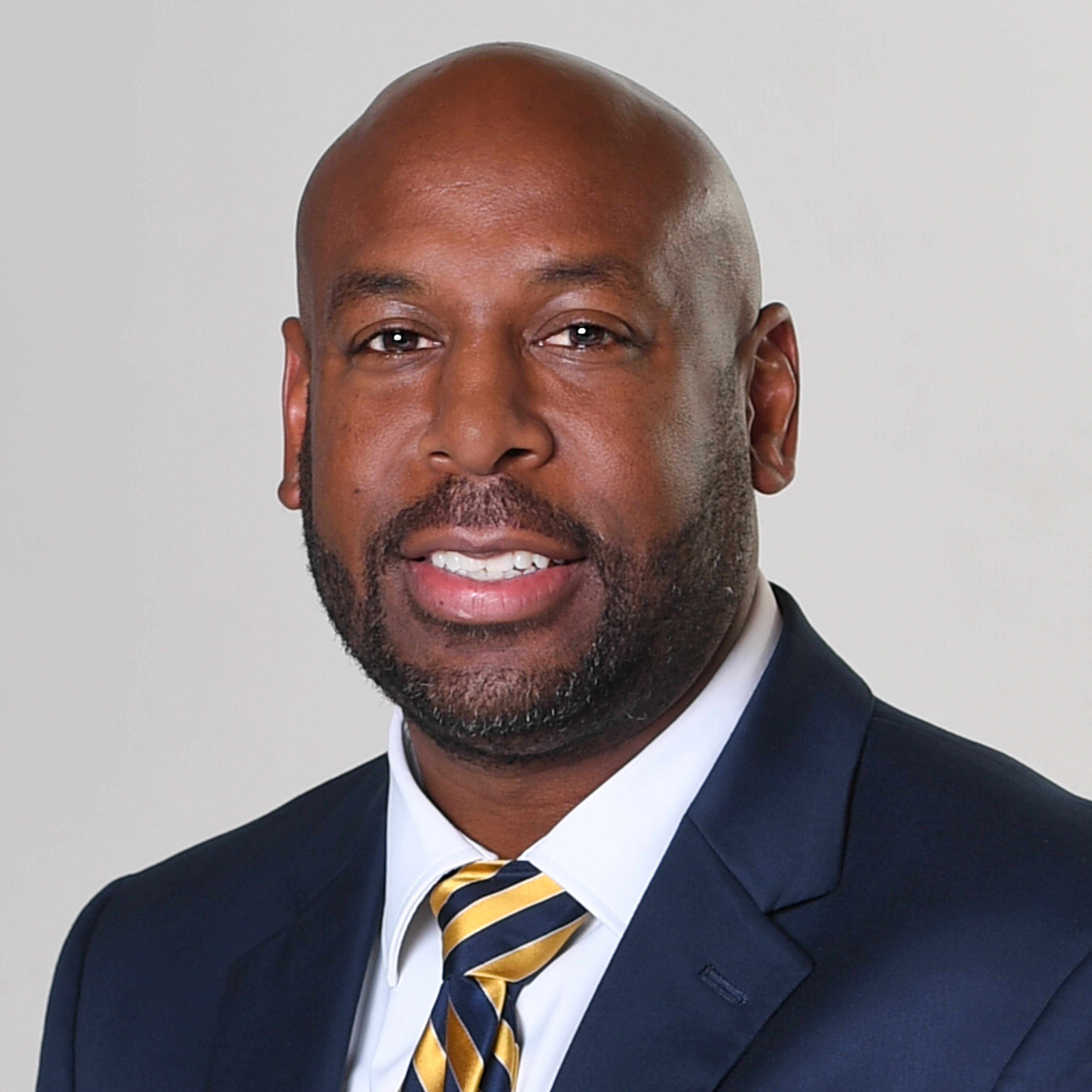 headshot of asst. superintendent; wearing dark suit, smiling