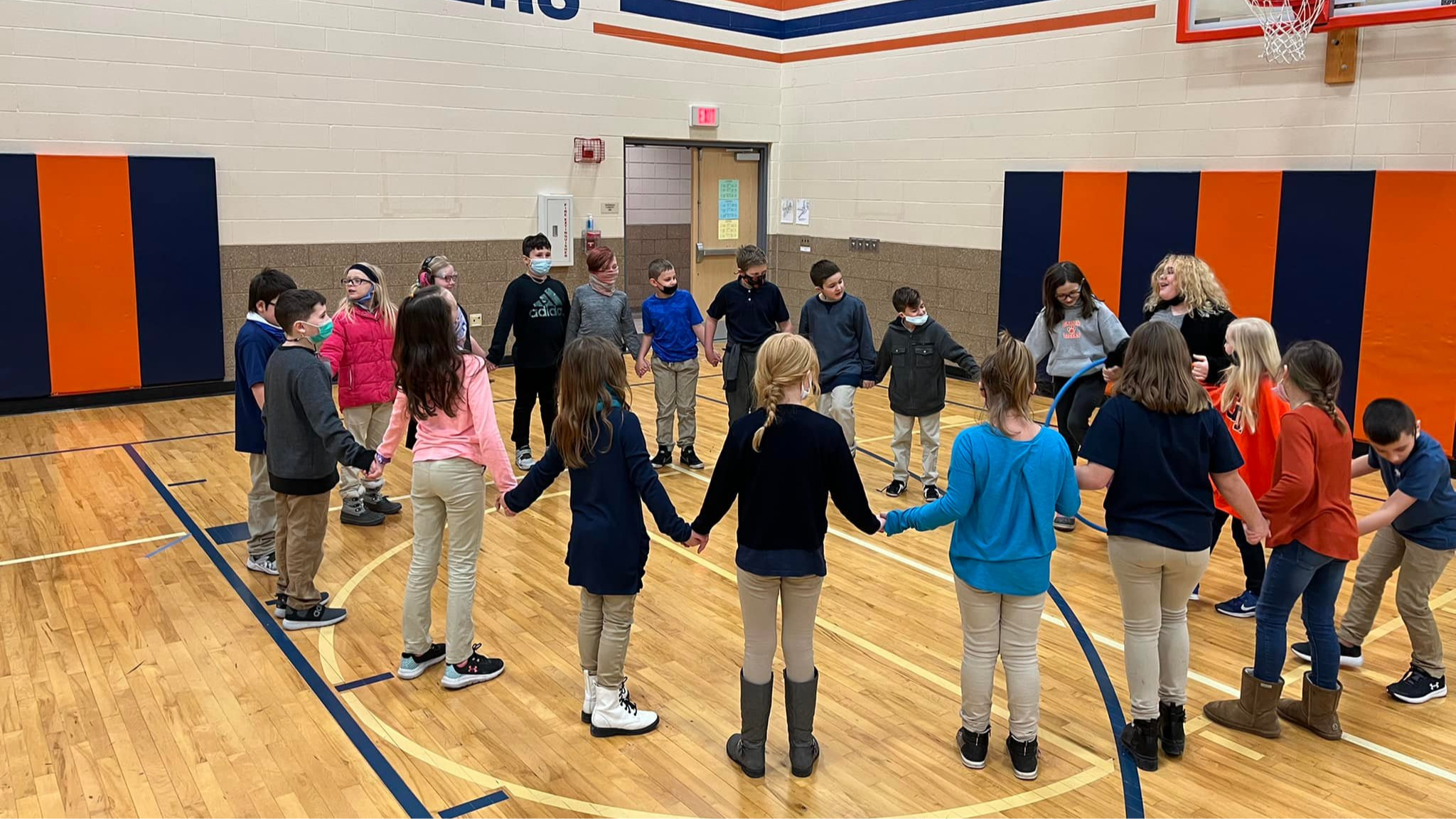 students holding hands in a circle