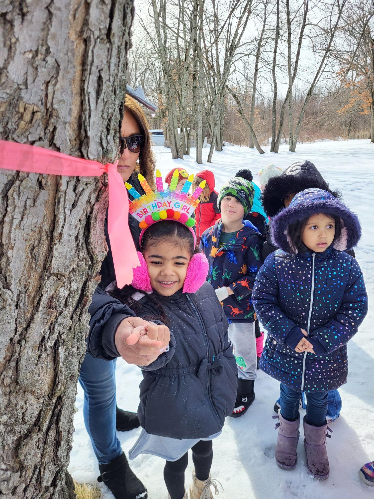 This birthday girl at Woodlawn got to taste maple sap directly from the tree they tapped in the school's yard.