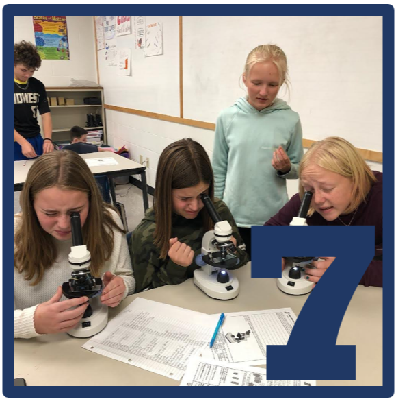students with microscopes