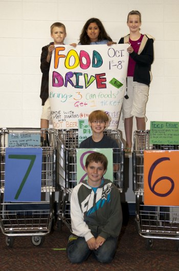 Students standing in carts advertising a food drive