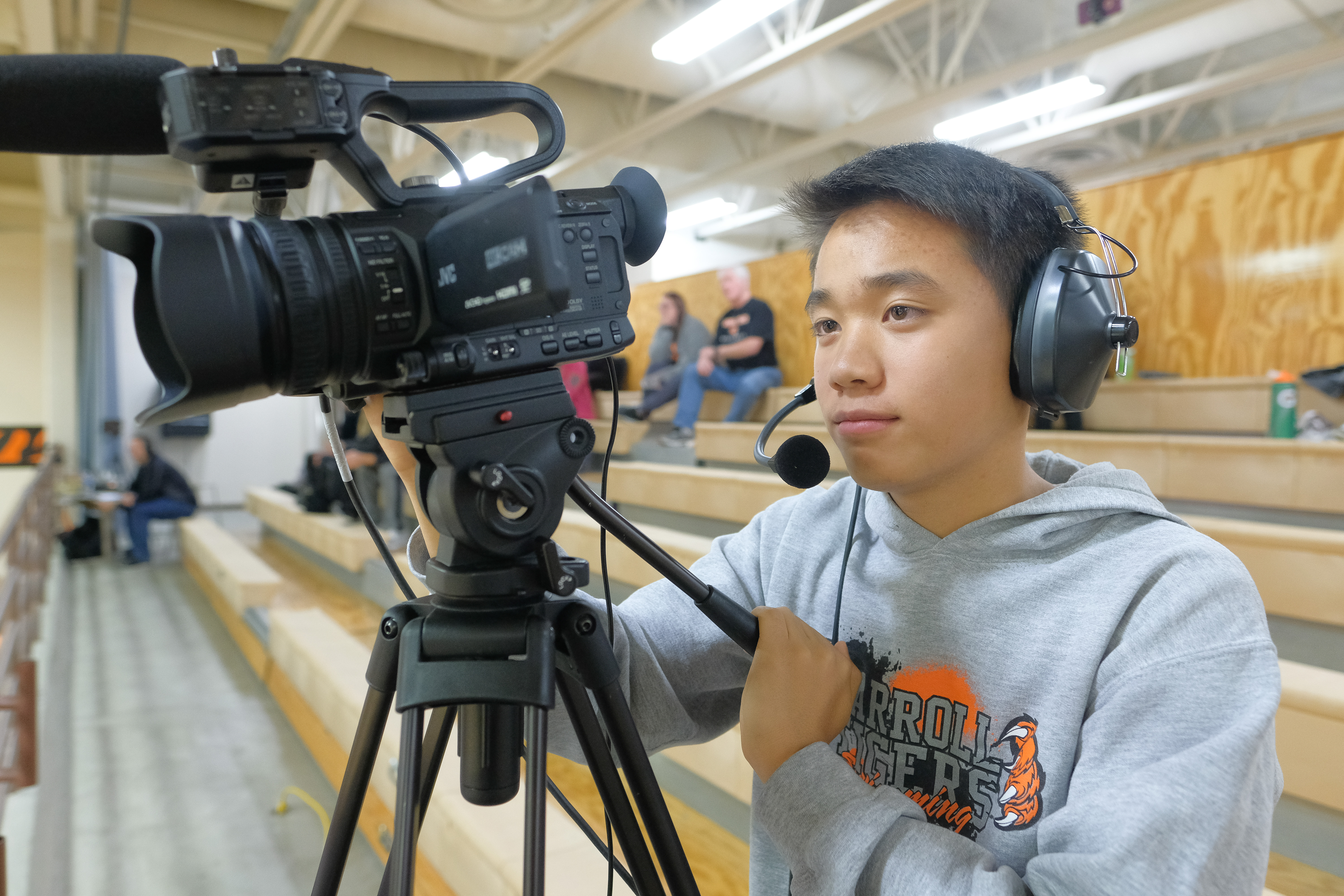 student using video camera to film game