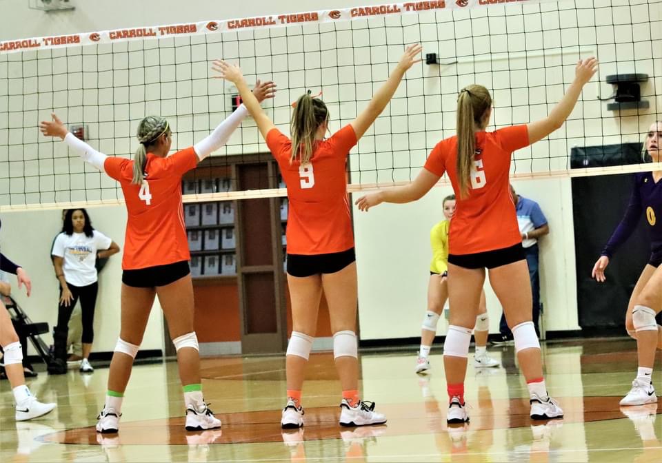 volleyball girls standing at net