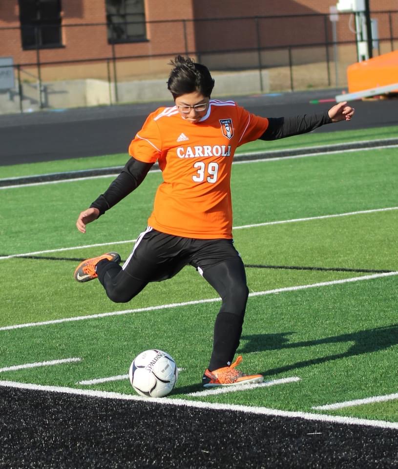 boy kicking soccer ball