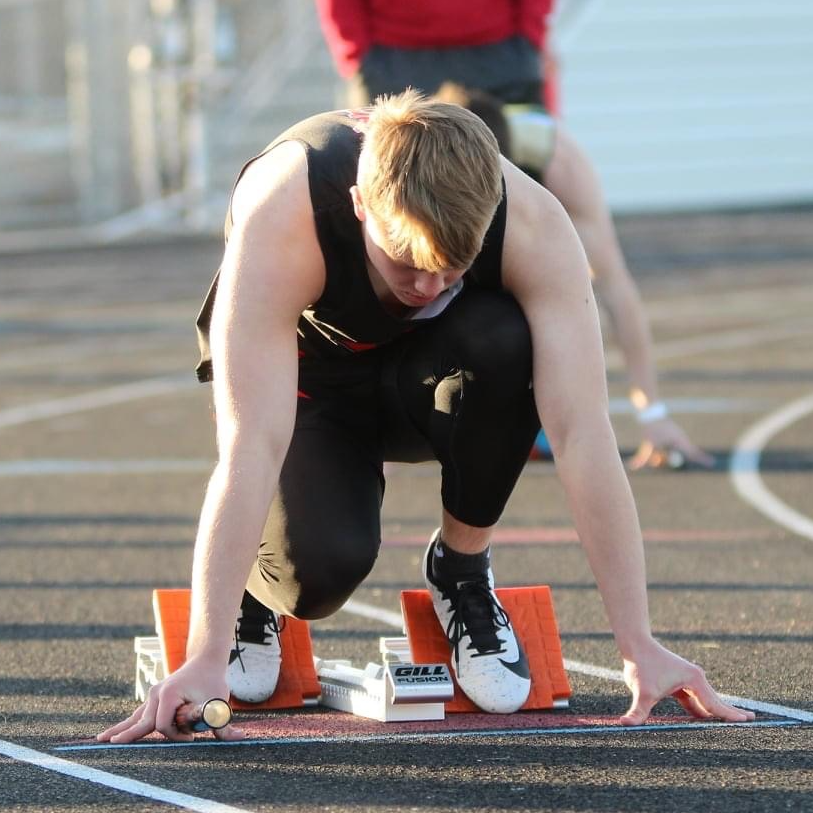 boy in track starting blocks getting ready to race