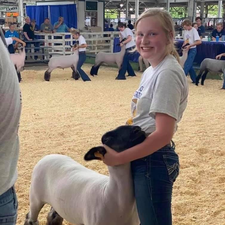 girl in FFA showing sheep