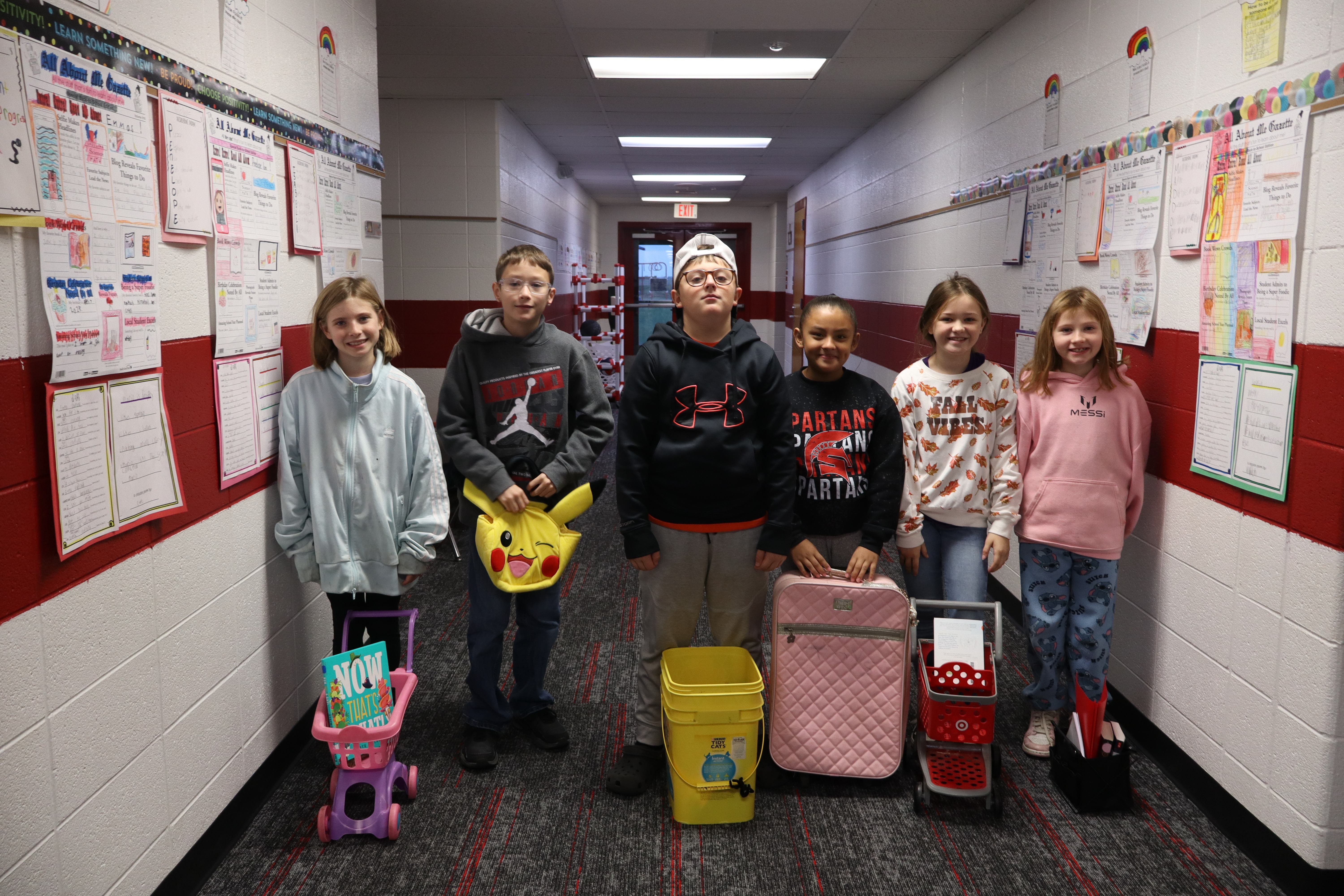 Elementary students in main hallway smiling