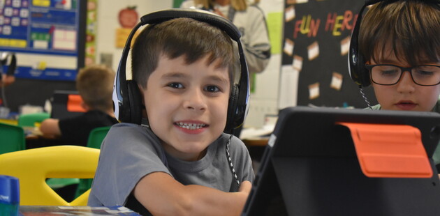 student in classroom working on computer