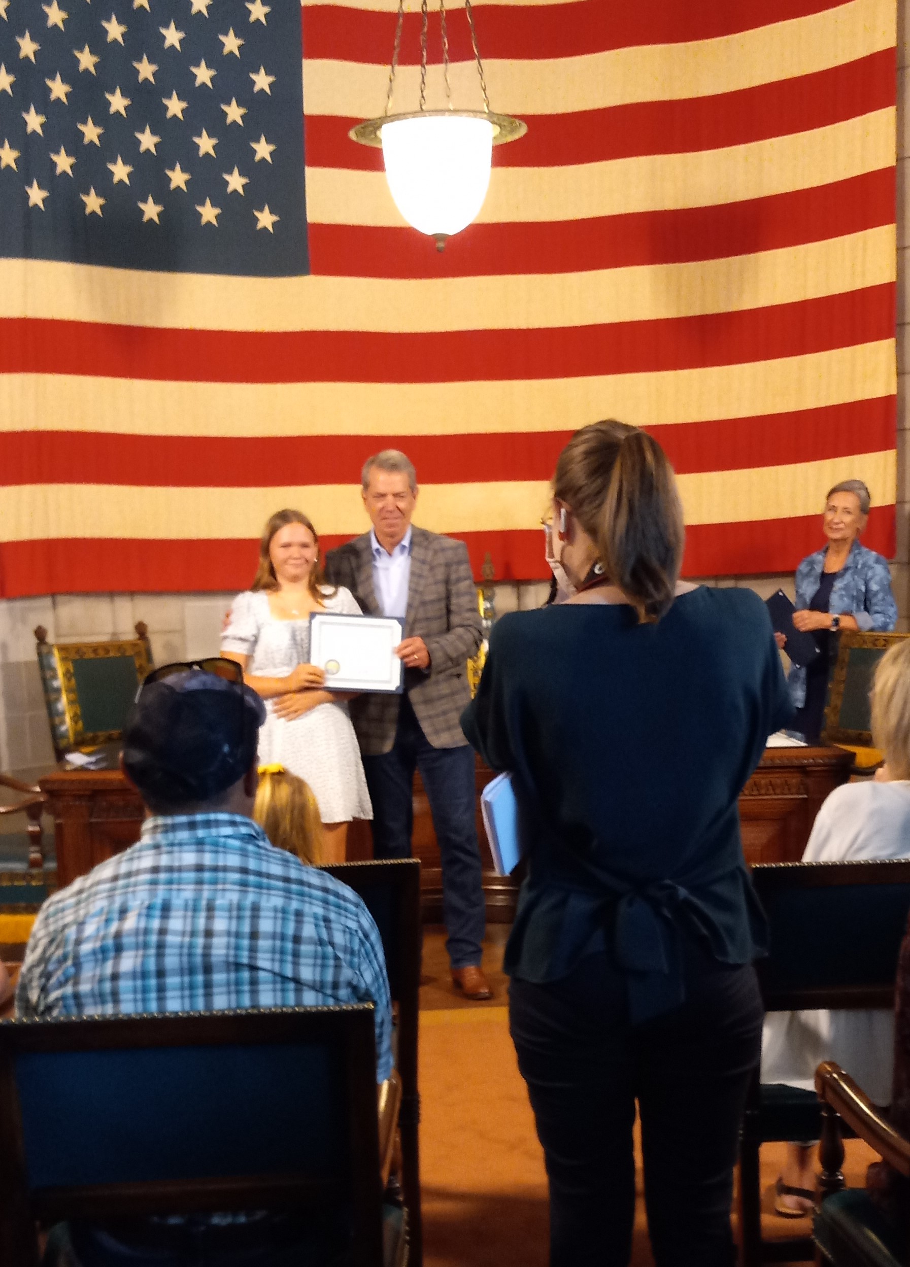 Kassidi receiving her award from Governor Pillen