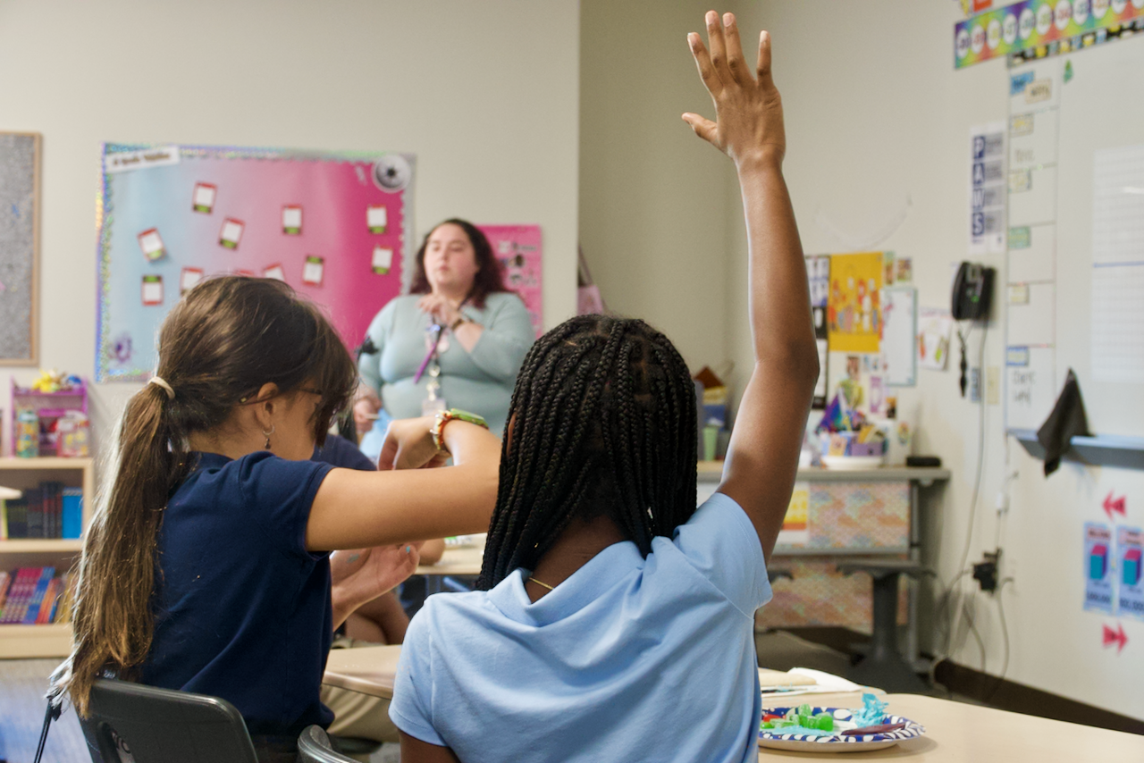 Student raising hand in class