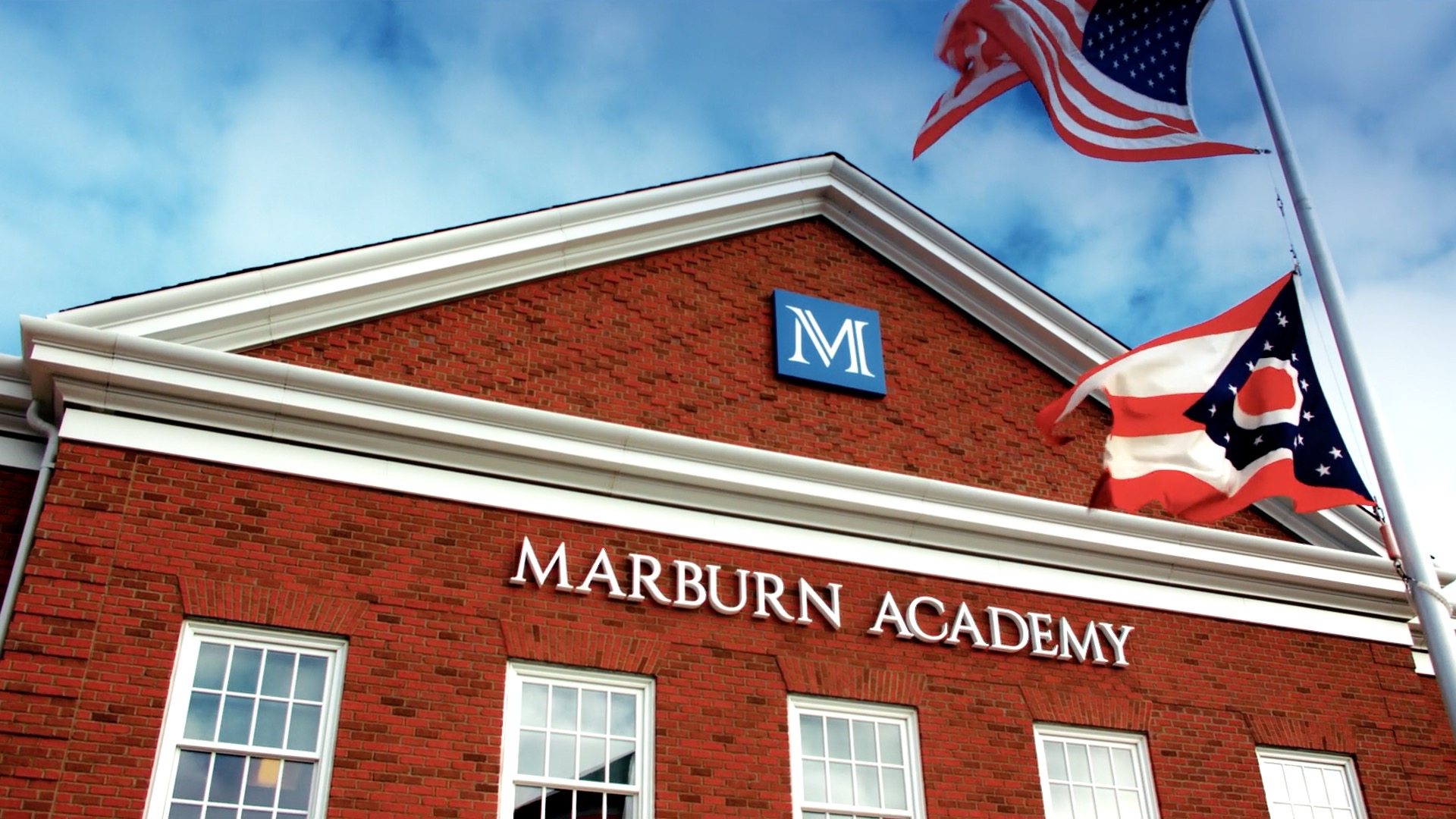 Exterior picture of front entrance of Marburn Academy with American and Ohio flag in the forefront