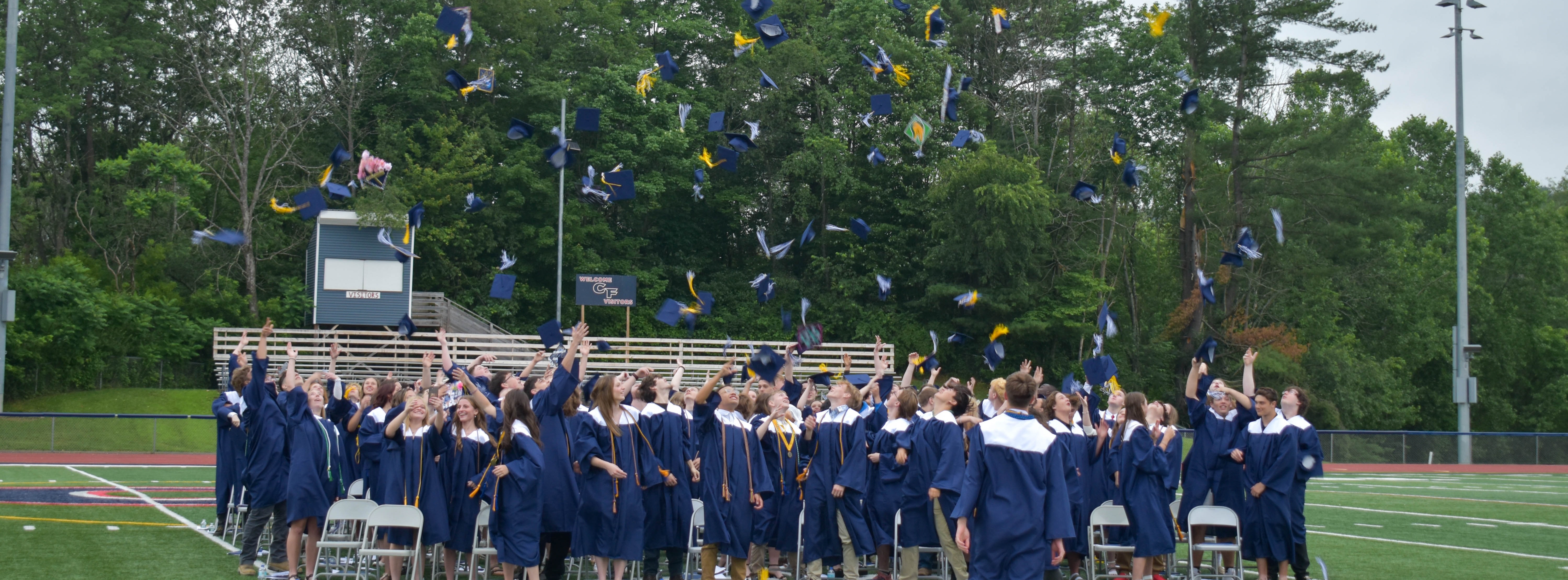 graduates throwing caps