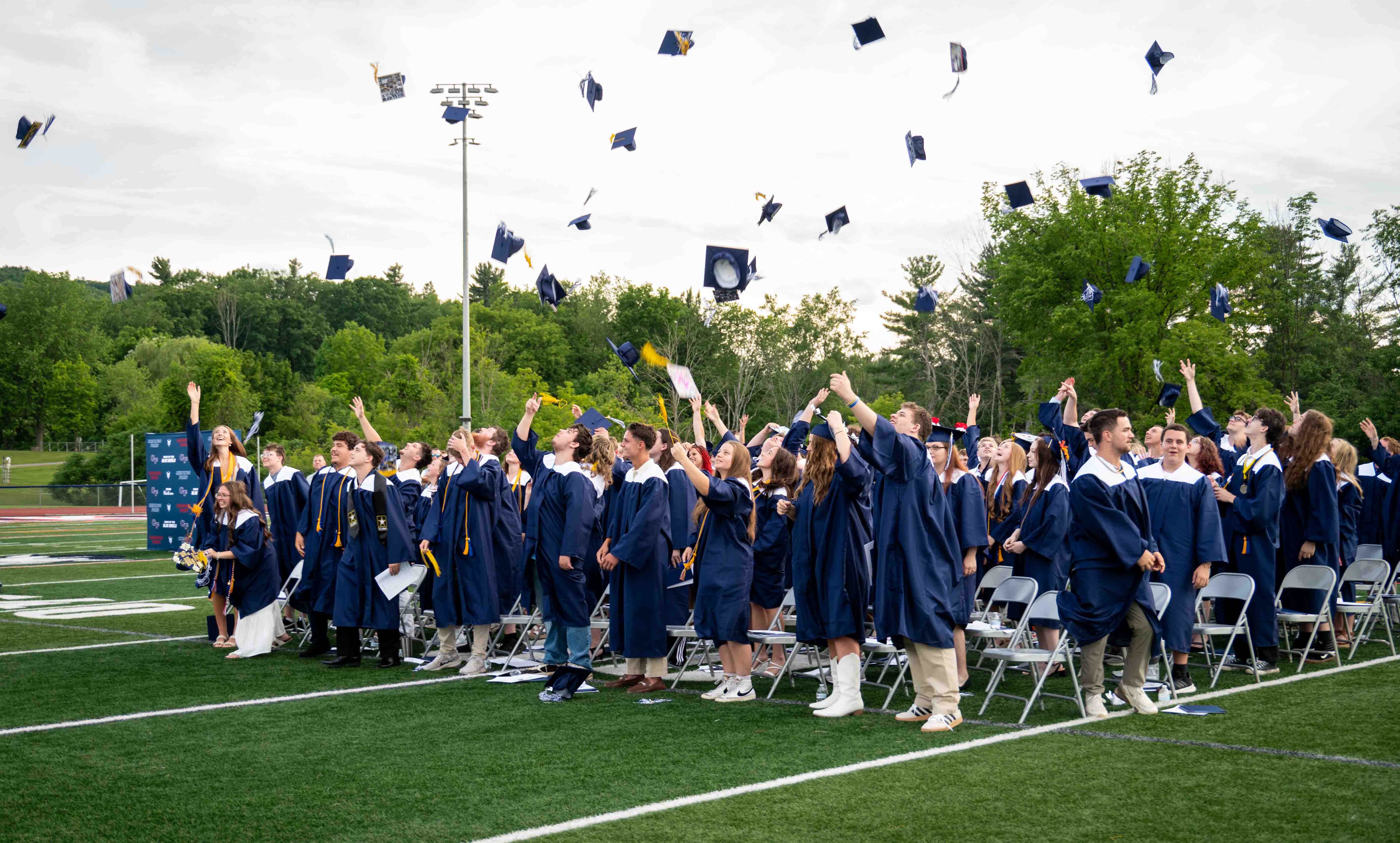 graduates throwing caps