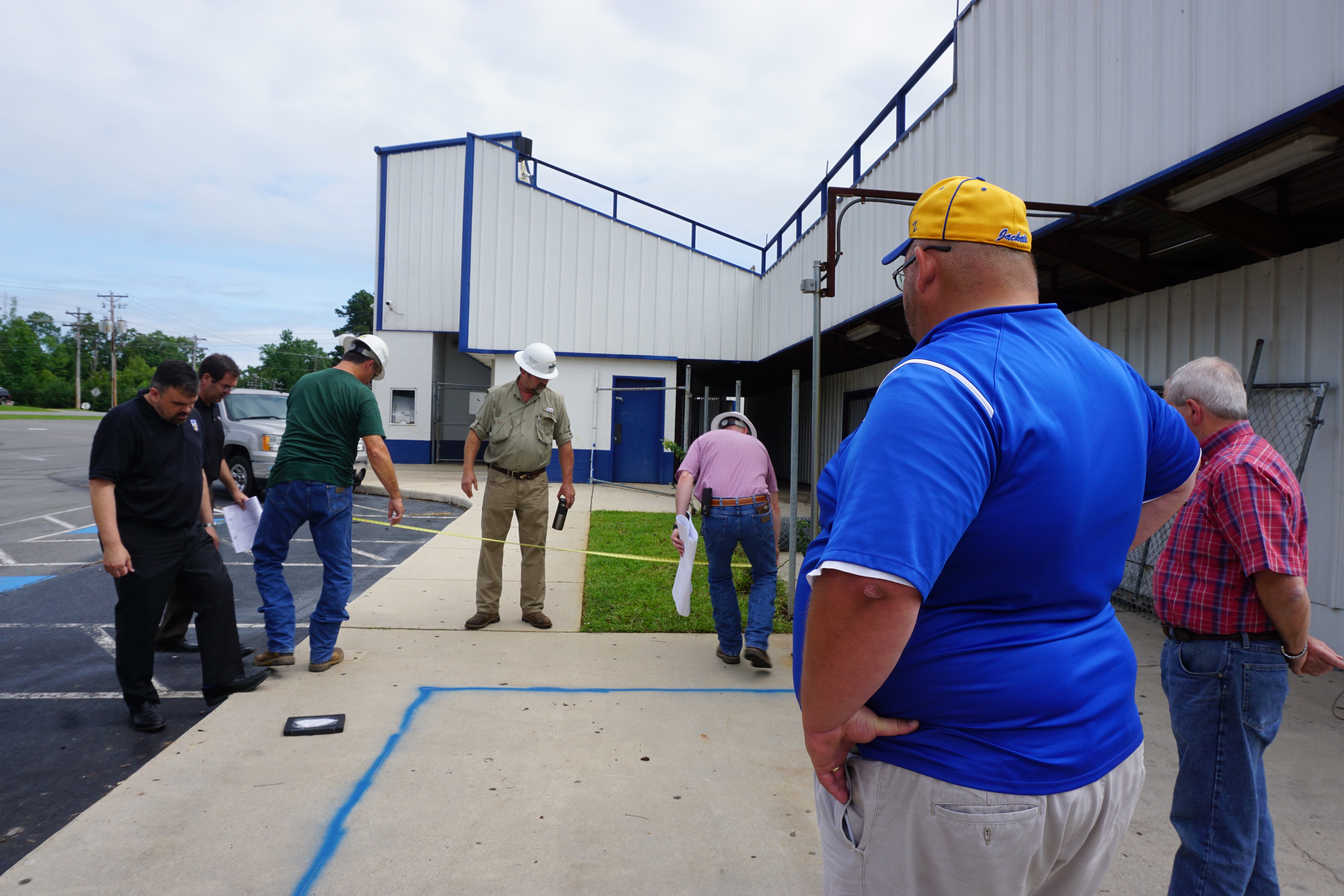 A photo of Superintendent Jerrod Williams, Athletic Director Matt Scarbrough and Maintenance & Transportation Director Mickey Siler meet with Nabholz Construction representatives at the Yellowjacket Stadium.